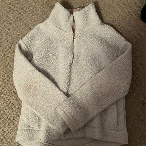 White fuzzy jacket with pink inner collar and zipper